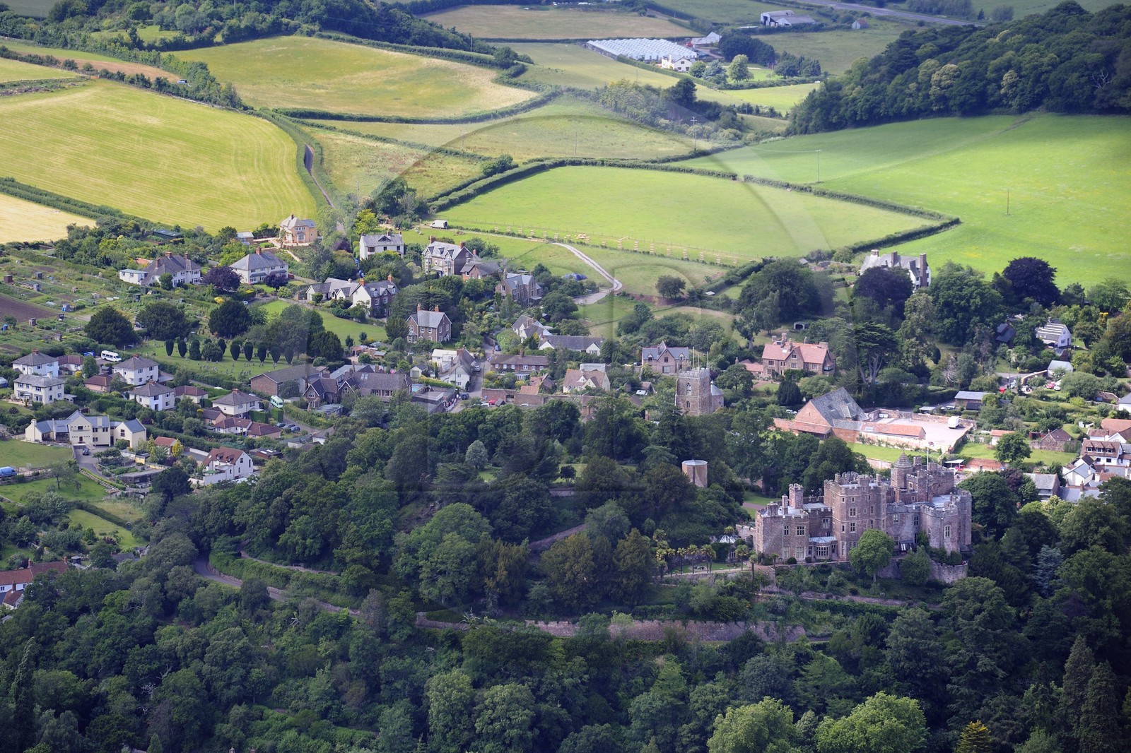 United Kingdom, England, Somerset, Dunster Castle is a former motte and bailey castle that belonged to the Luttrell family (aerial view)