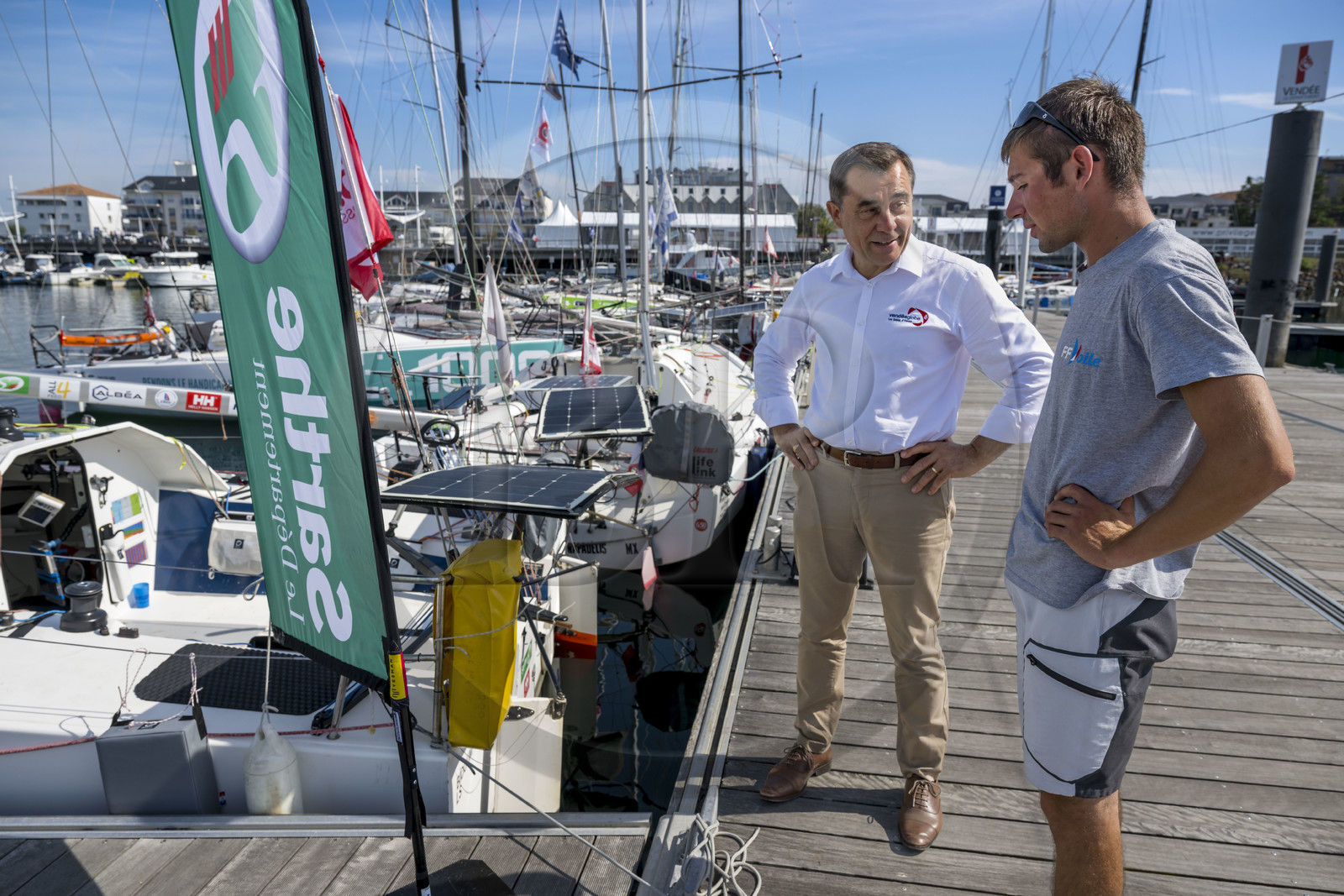 France, Vendée (85), Les-Sables-d'Olonne, Port Olona, ponton des voiliers du Vendée Globe, bateau à voile monocoque de régate de classe Mini 6,50 se préparant à participer à la minitransat, le président de la course du Vendée Globe Alain Leboeuf en discussion avec le jeune skipper Hugo Cardon