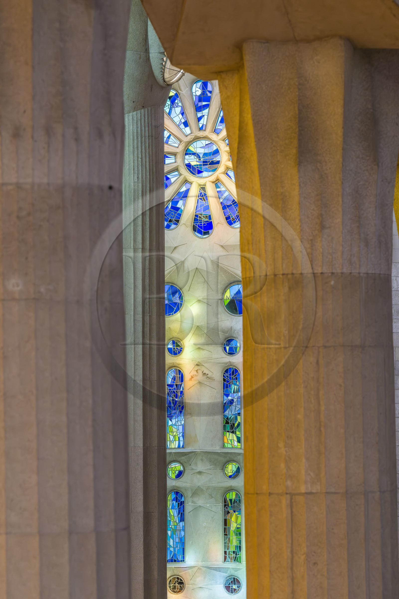 Spain, Catalonia, Barcelona, Eixample district, Sagrada Familia basilica by Catalan modernist architect Antoni Gaudi, listed as a UNESCO World Heritage Site, columns of the central nave and the transept of the Passion facade dedicated to water, resurrection and light in the background