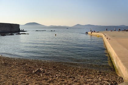 France, Var, Saint-Tropez, Plage de la Ponche Beach where are built the high houses with facade of ochre, yellow or orange colors