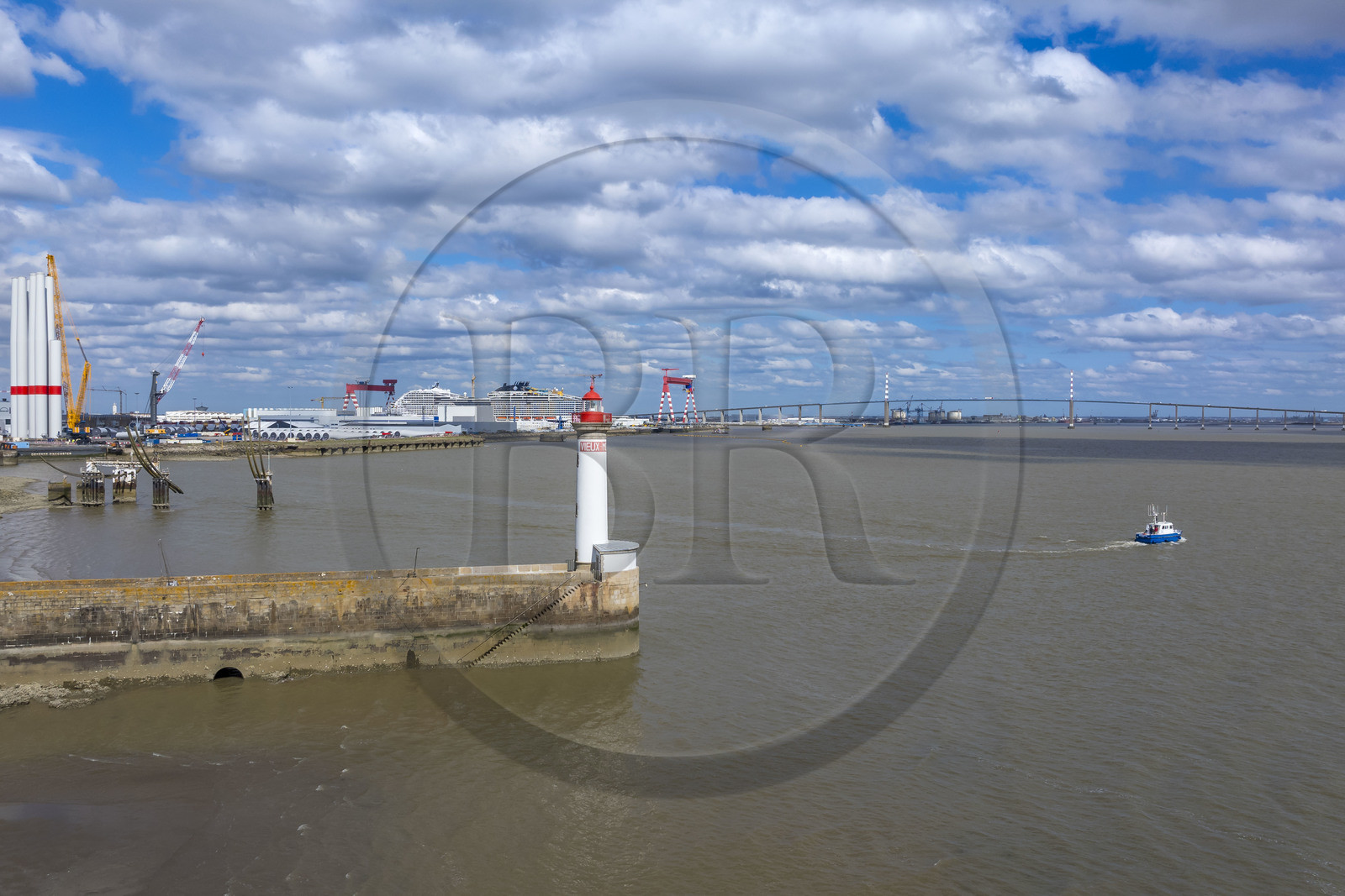 France, Loire-Atlantique (44), Saint-Nazaire, le phare du Vieux Mole,  le paquebot de 333m MSC World America construit par les Chantiers de l'Atlantique et le pont de Saint-Nazaire en arrière plan (vue aérienne)