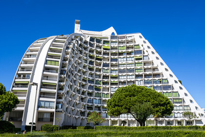France, Herault, La Grande-Motte, labeled 20th century heritage, The Great Pyramid built in 1974 by the architects Jean Balladur and Jean-Bernard Tostivint, this flagship building for the port of the seaside resort dominates the whole city, forms a curved Y plan and houses a hotel and apartments