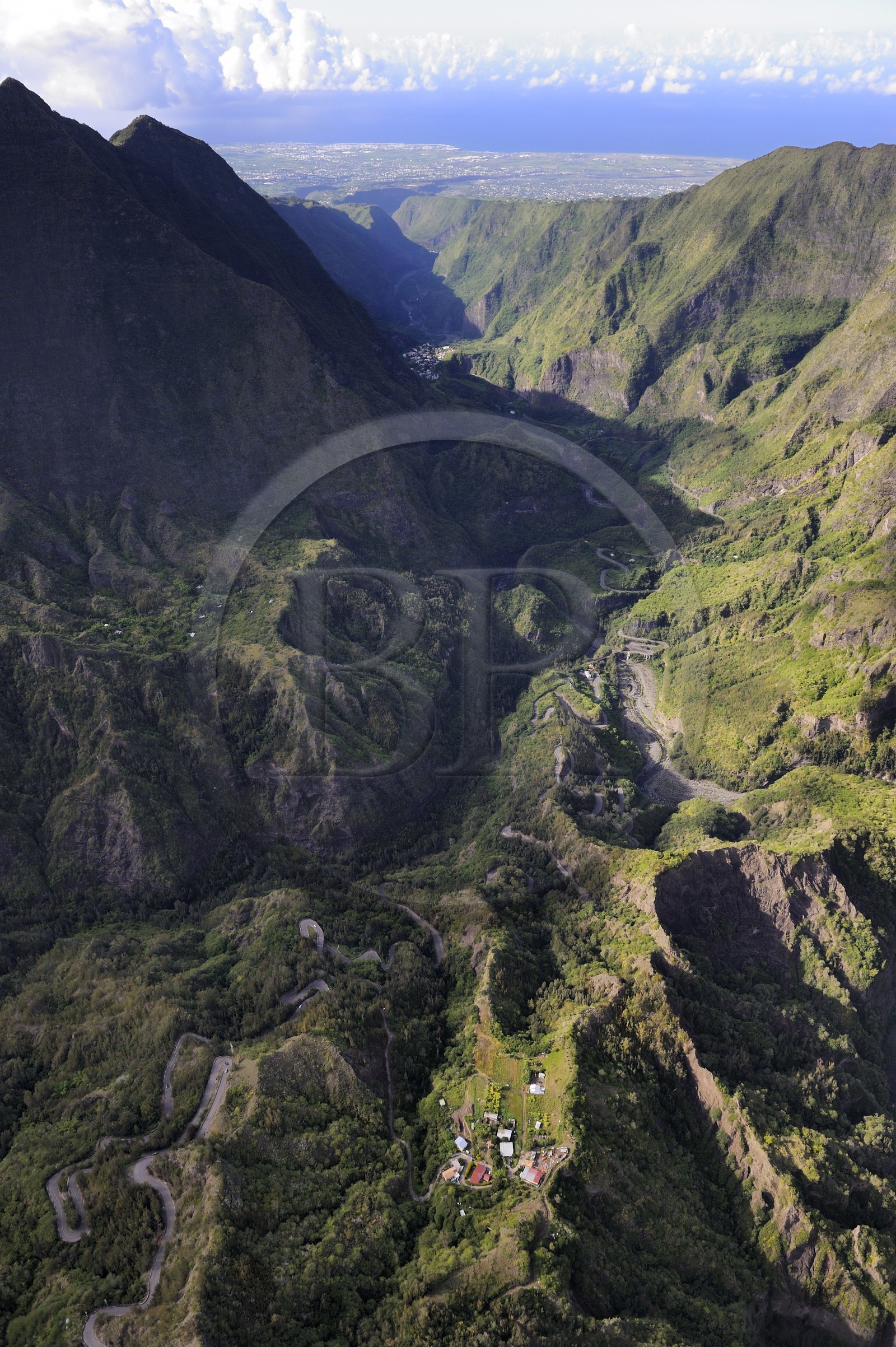 France, Reunion island (French overseas department), cirque of Cilaos, listed as World Heritage by UNESCO, National Highway 5 access road to the cirque also known as the 400 turns road and the West coast towards St. Louis in the background (aerial view)