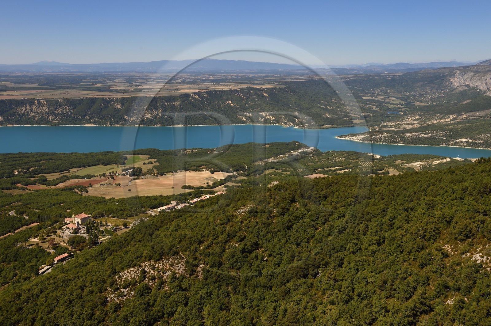 Var on the Left Bank and Alpes de Haute Provence on the Right Bank, Parc Naturel Regional du Verdon, Lake St Croix at the exit of the Gorges du Verdon, in the foreground the Renaissance castle of Aiguines and the St. John's Church (aerial view)