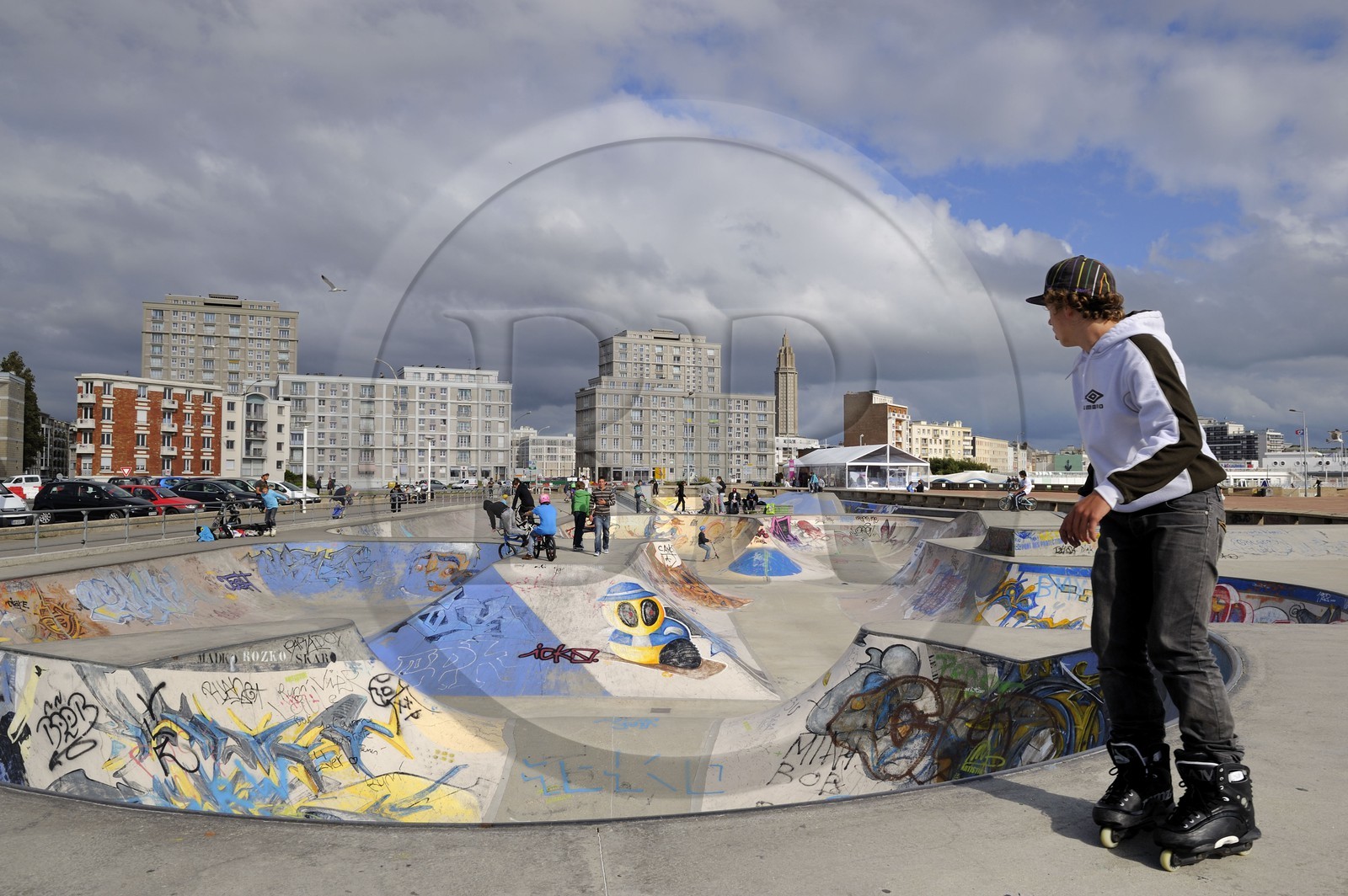 France, Seine Maritime, Le Havre, Downtown rebuilt by Auguste Perret listed as World Heritage by UNESCO, the Skate park on the beach, Perret buildings of Porte Océane (Ocean Gate) and St. Joseph's Church in the background