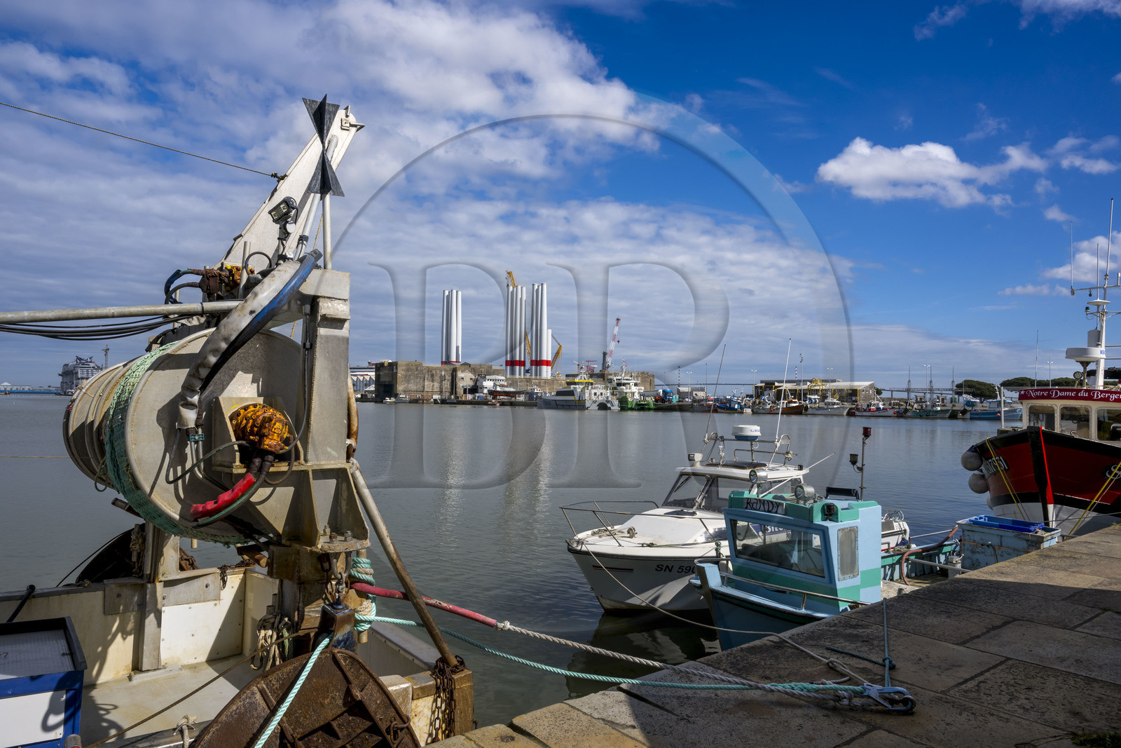 France, Loire-Atlantique, Saint-Nazaire, fishing boats in the harbour basin and the fortified lock of the former German submarine base built during the last world war in the background