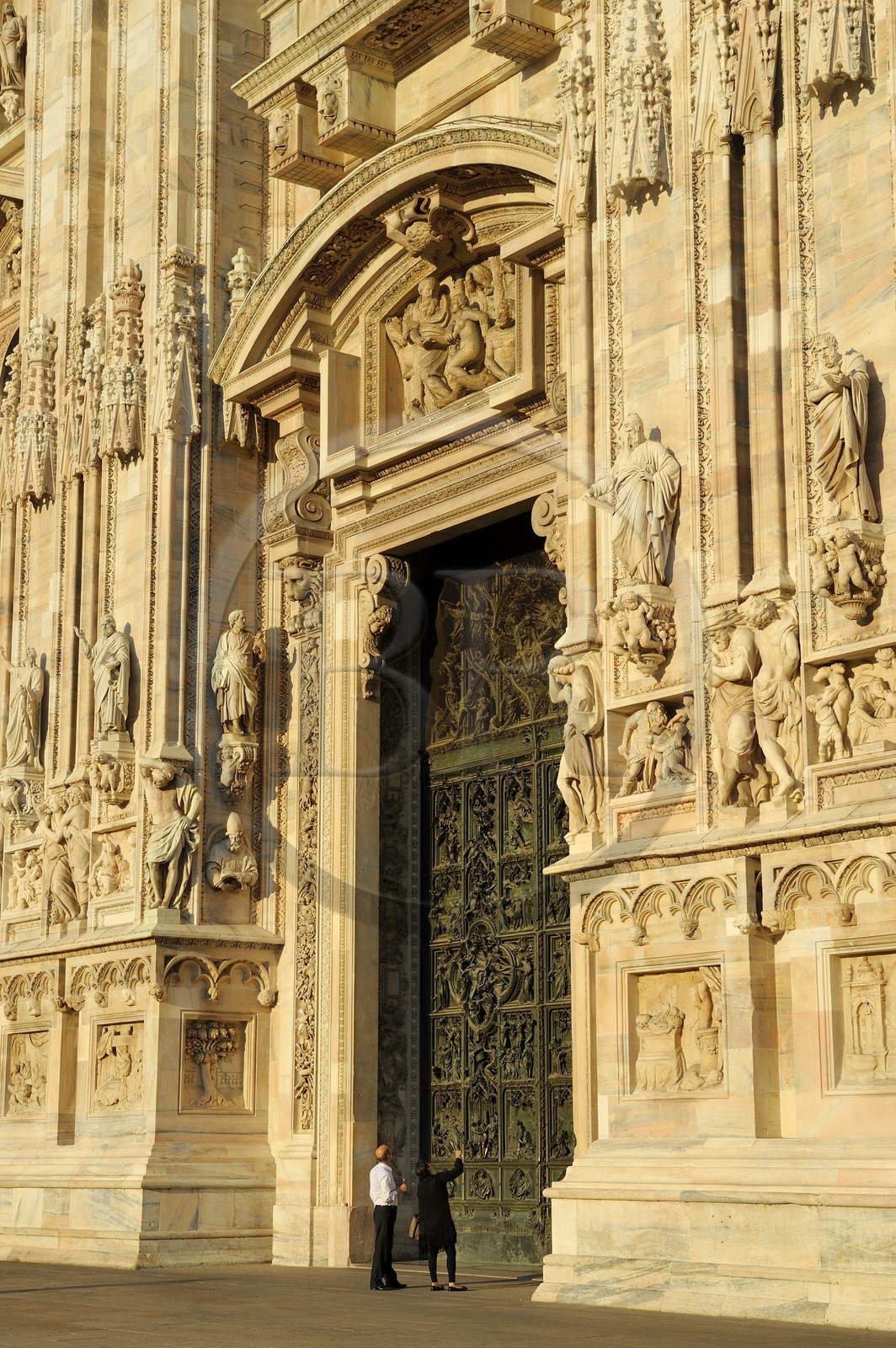 Italy, Lombardy, Milan, the Duomo in the historical center, cathedral in Gothic Flamboyant style, central portal surmounted by a tympanum representing the Creation of Eve (drawings by Cerano)