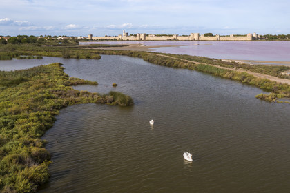 France, Gard, Aigues Mortes, the medieval town surrounded by its ramparts on the edge of the salt marshes (Salins du Midi) (aerial view)