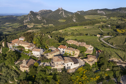 France, Vaucluse, Dentelles de Montmirail mountains, the village of Suzette surrounded by vineyards, the Clapis extended by the Grand Montmirail on the left, the Dentelles Sarrasines in the center and the Grand Travers on the right (aerial view)