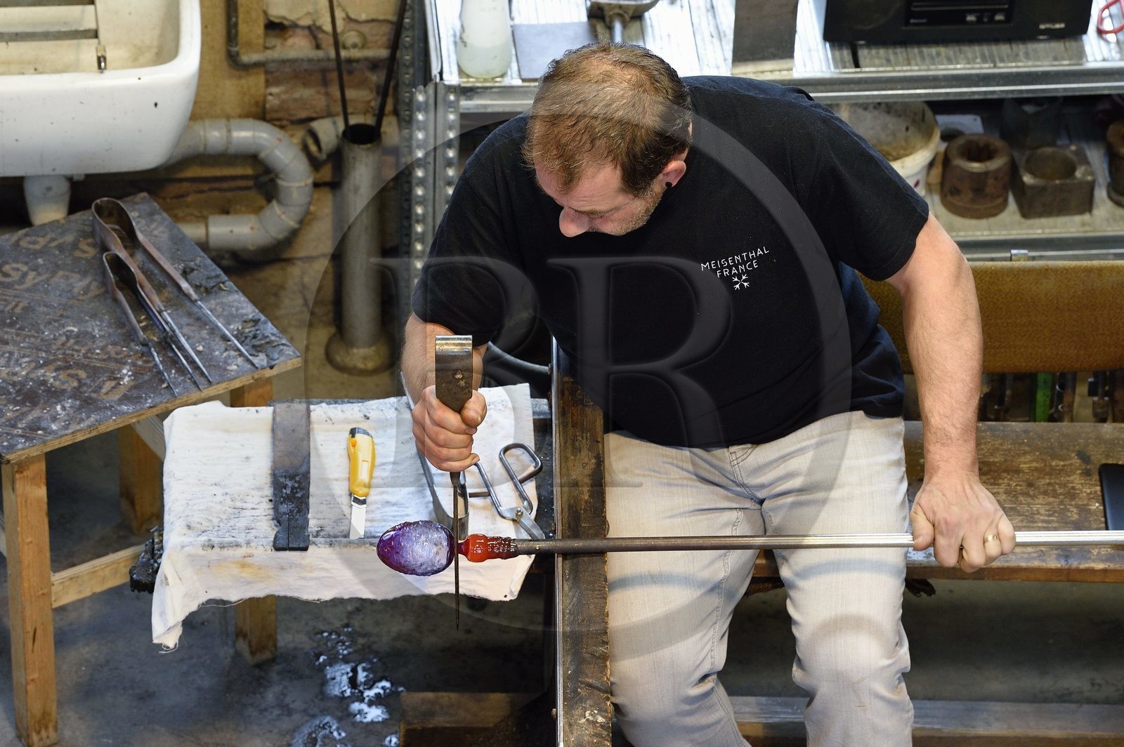 France, Moselle, Meisenthal, Centre international d'Art verrier (CIAV) (international glass centre), the blowing workshop, crafting a Christmas ball, shaping at the outlet of the blow mold by the master glassmaker Jean-Marc Schilt