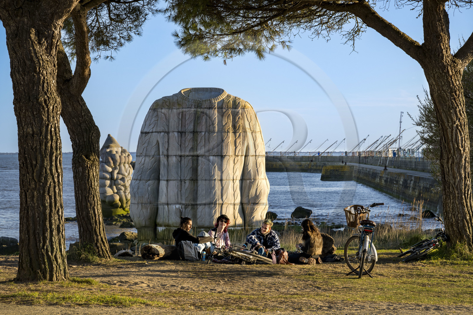 France, Loire Atlantique, Estuaire de la Loire, Saint Nazaire,  Estuaire open-air contemporary art collection, group of young people in front of one of three monumental concrete sculptures The foot, the sweater and the digestive system created by the artists Daniel Bewar and Gregory Gicquel on the edge of the Quai de la Jetée