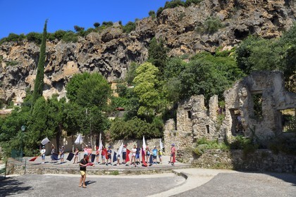 France, Var, Provence Verte, Cotignac, tufa cliff of 80 meters high and 400 meters wide, village children preparing a show in the open-air theater