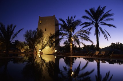 Tunisia, Southern Tunisia, Ksar Ghilane oasis, reflection of the watchtower in the swimming pool of Ksar Ghilane hotel