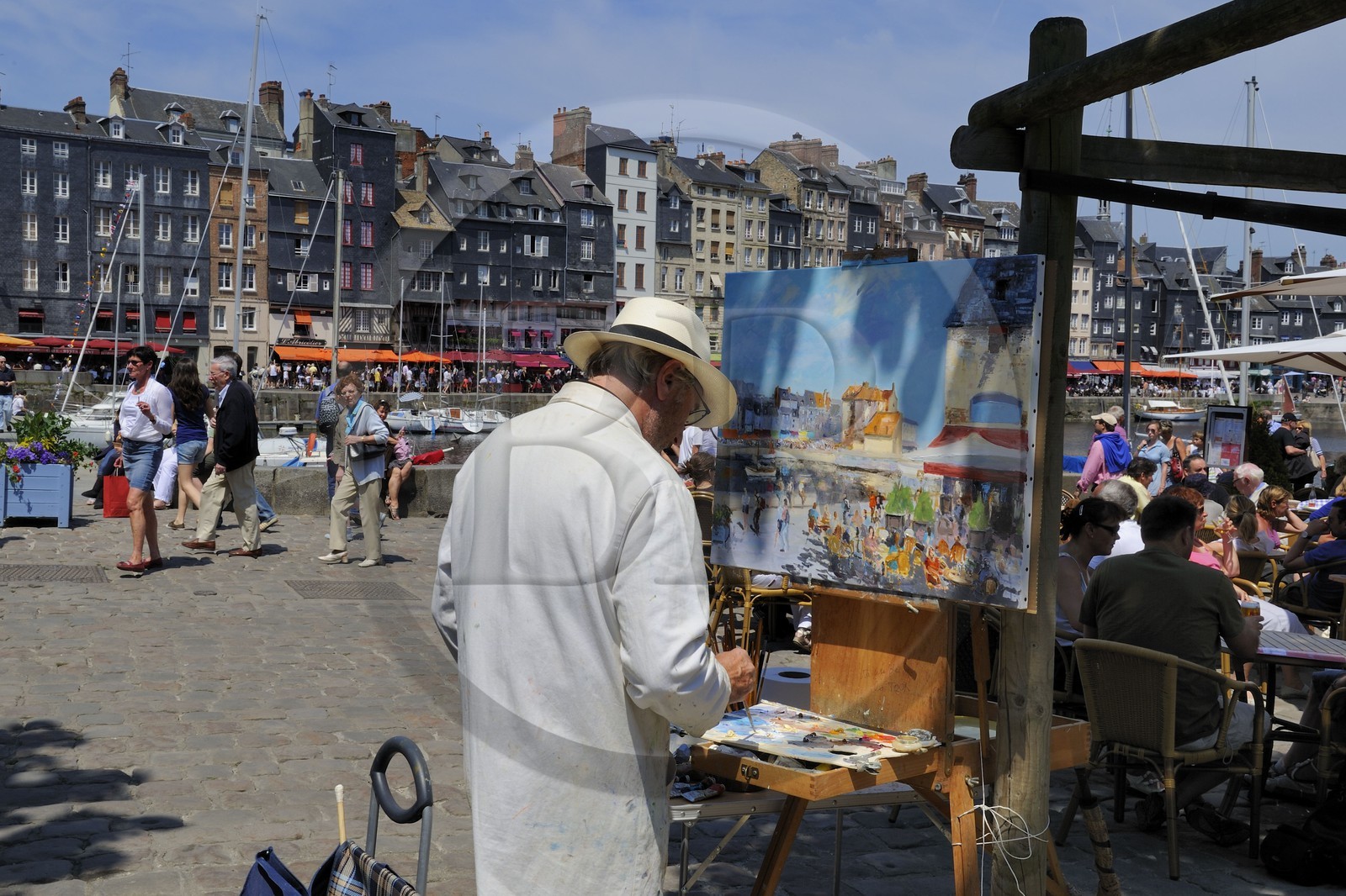 France, Calvados, Honfleur, the local painter Daniel Lallemand painting the Vieux-Bassin (Old Basin)