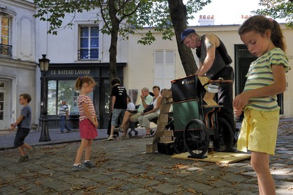 France, Paris (75), Butte Montmartre, Valmy qui est musicien de rue à l'Orgue de barbarie sur la place Emile Goudeau et le bateau Lavoir en arrière plan