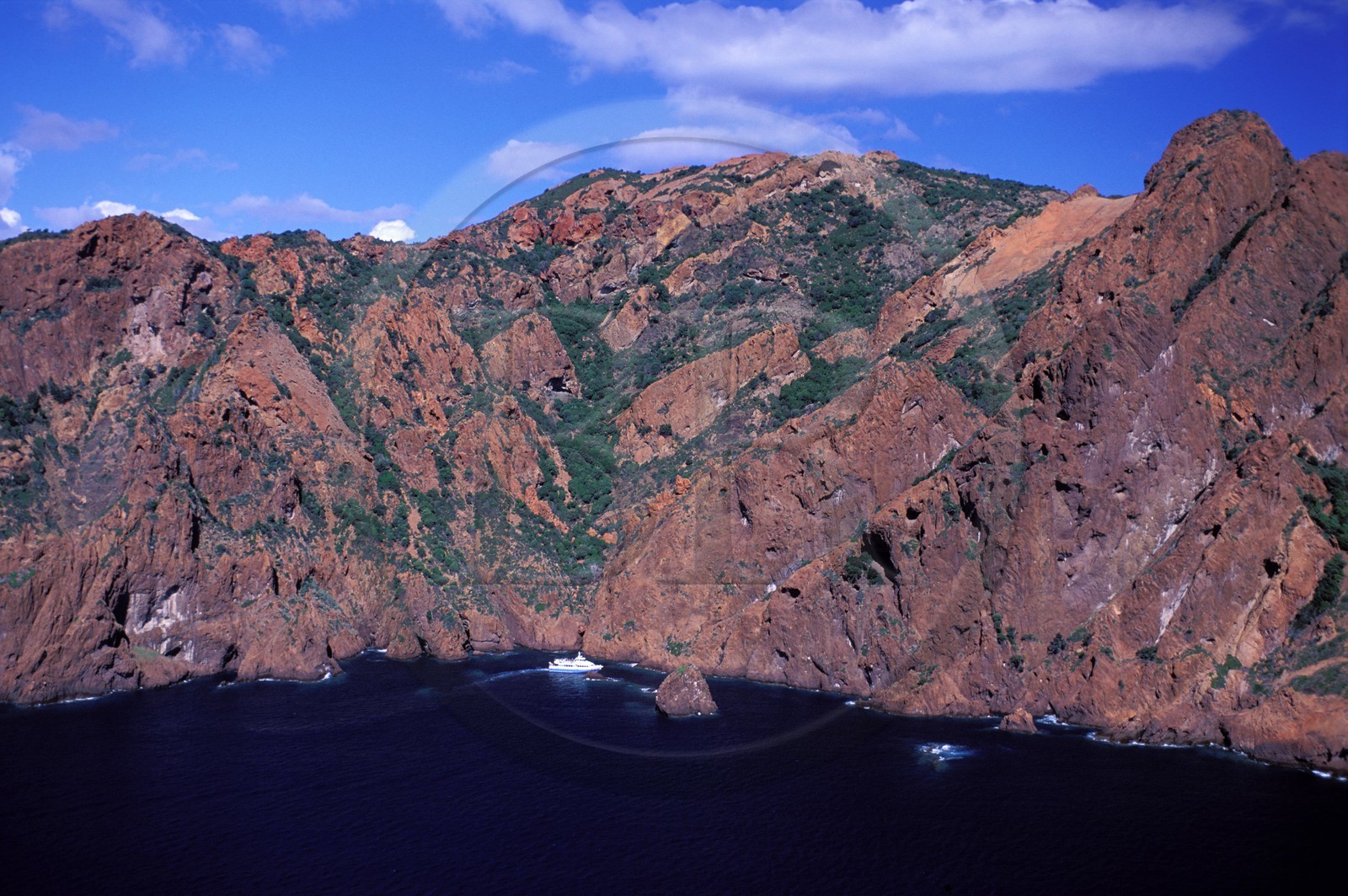 France, Corse du Sud, boat in the Scandola Nature Reserve listed as World Heritage by UNESCO (aerial view)