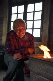 France, Vosges, Ballons des Vosges Regional Natural Park, Saint Maurice sur Moselle, the chalet des cretes, a log shelter built by foresters and open to hikers who can warm themselves around the stove, Robert Jacquot President of the Remiremont section of the club vosgien