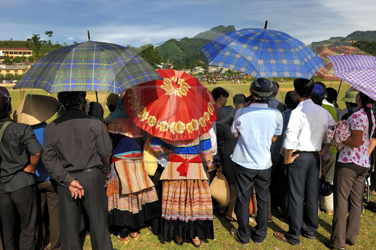 Vietnam, Lao Cai province, Bac Ha, annual race of horses and two women from the Flower Hmong minority in foreground