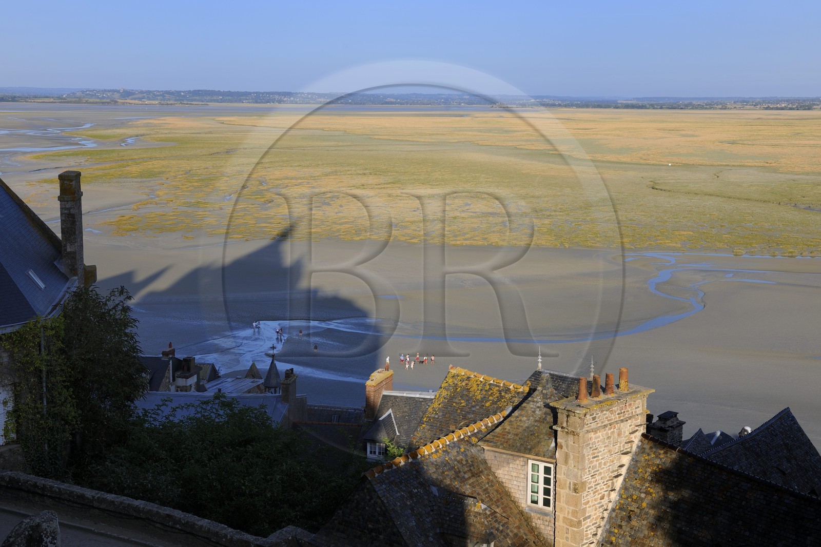 France, Manche, Mont Saint Michel, listed as World Heritage by UNESCO, shadow of the abbey on the bay and the salt marshes on the East