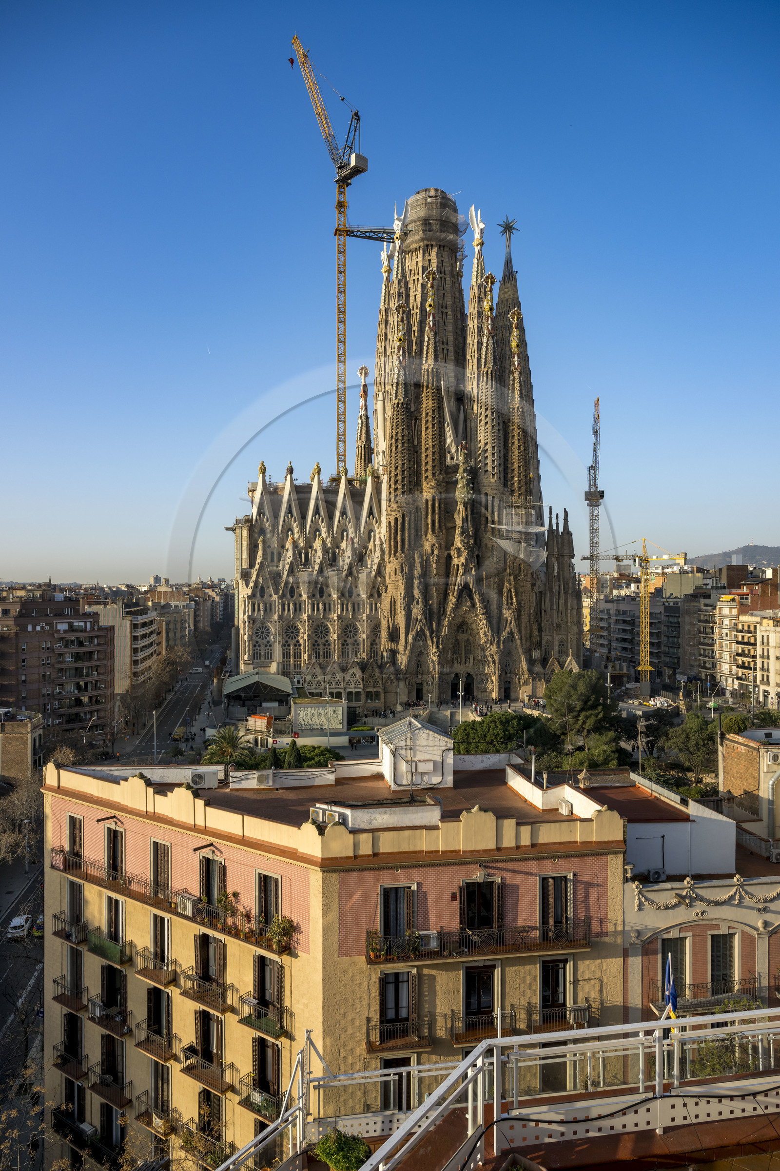 Spain, Catalonia, Barcelona, Eixample district, Sagrada Familia basilica by Catalan modernist architect Antoni Gaudi, listed as a UNESCO World Heritage Site, facade of the Nativity and the surrounding buildings