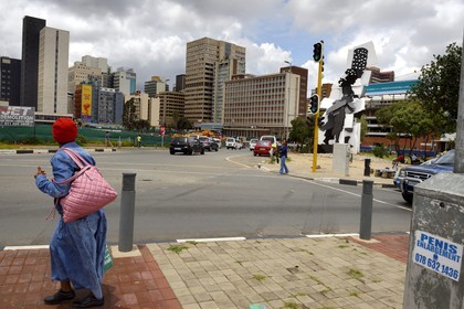 South Africa, Gauteng Province, Johannesburg, CBD (Central Business District), the Fire Walker sculpture by William Kentridge and Gerhard Marx represents a woman carrying a brazier on her head in commemoration of the activity which took place in the area in recent years, when ladies would prepare and sell their fires to others preparing food