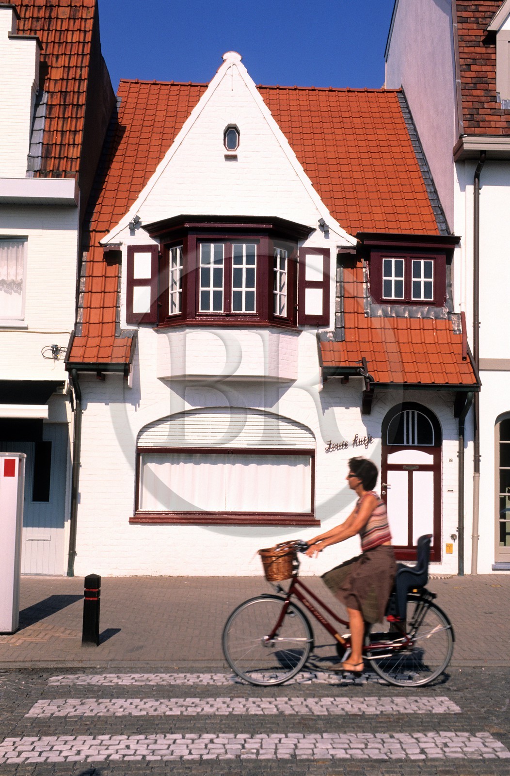 Belgium, West Flanders, Knokke-le-Zoute, cyclist in the old town centre