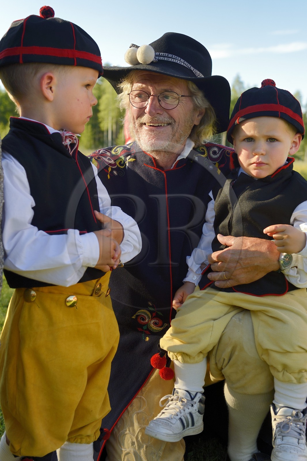 Sweden, Dalarna County, Leksand area, Midsummer celebrations in the tiny hamlet of Hjulbäck, Man and grandchildren in traditional costume