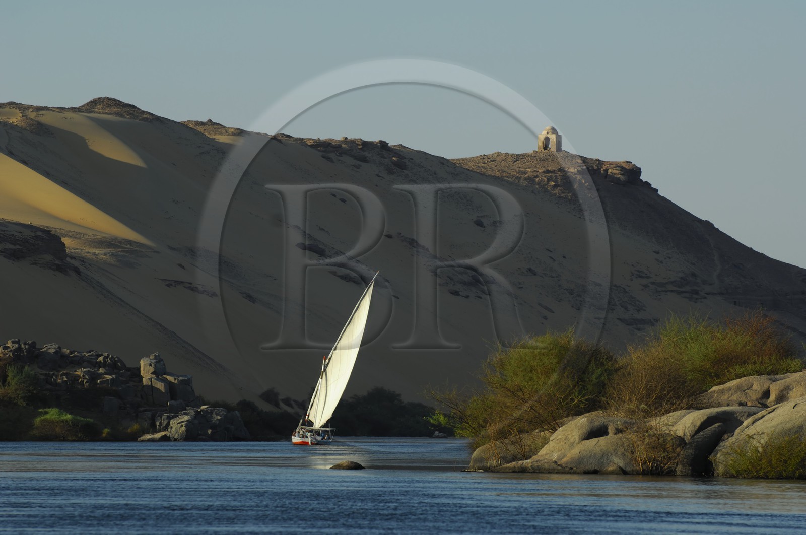 Egypt, Upper Egypt, Nile Valley, Aswan, felucca on the Nil and sand dunes of the western bank