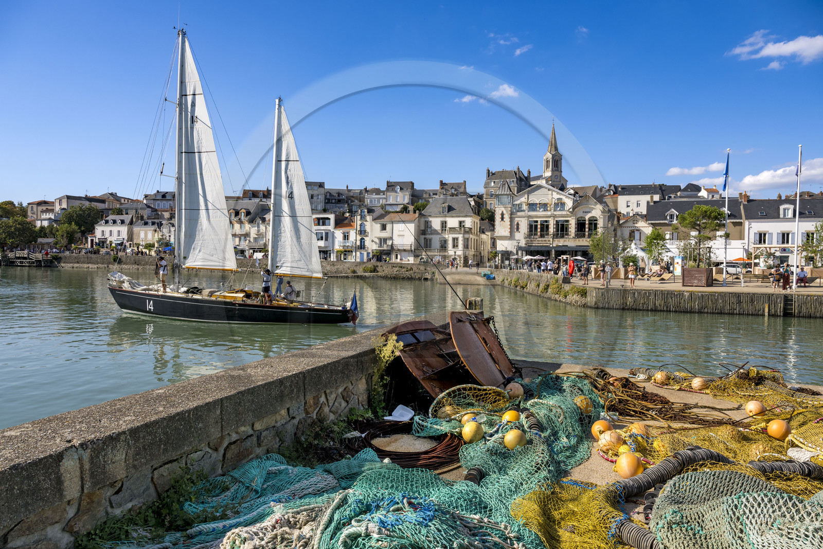 France, Loire Atlantique, Pornic, the Pen Duick II sailboat leaving the port under sail, the Saint-Gilles church in the background