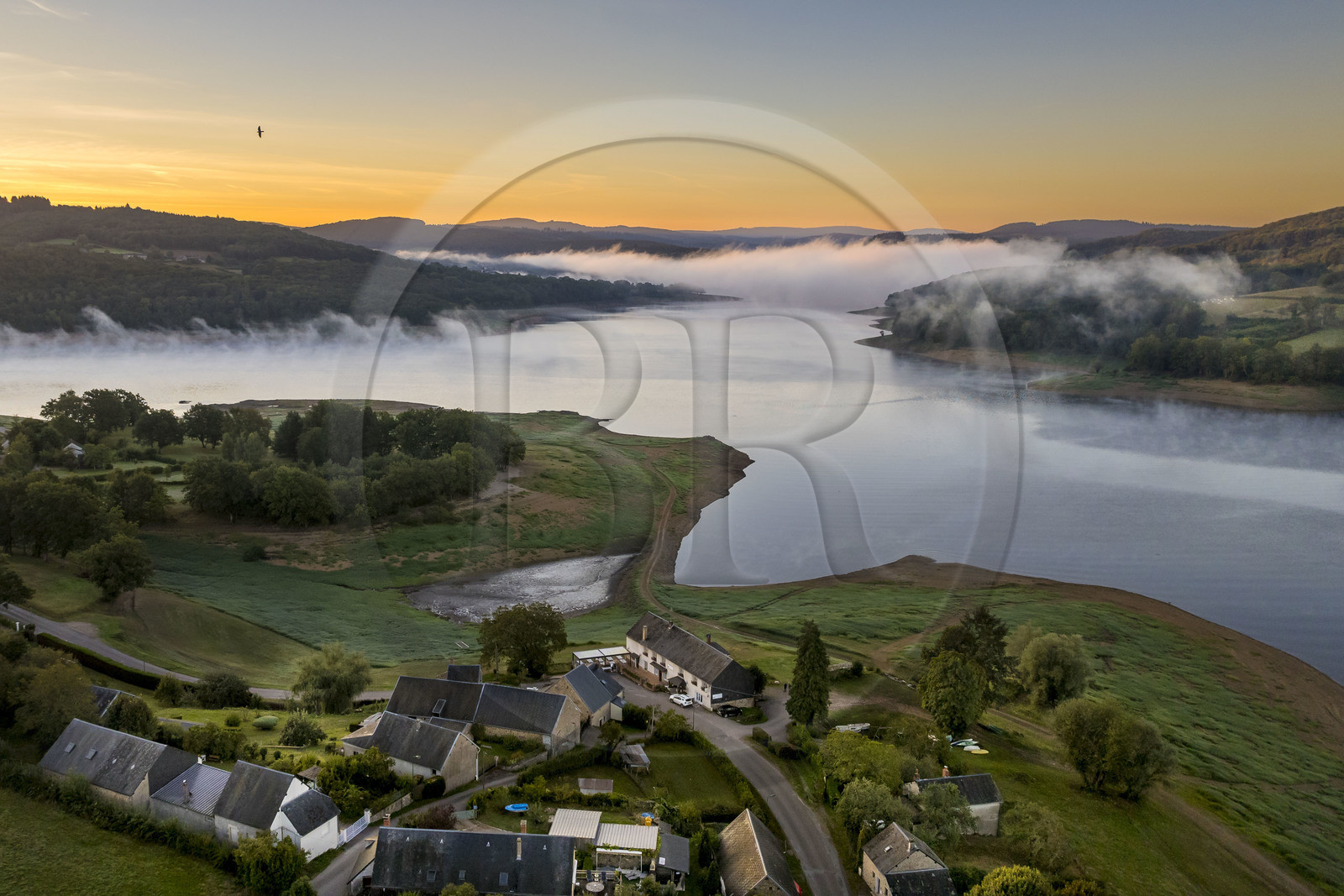 France, Nievre, Regional Natural Park of Morvan, Chaumard, Pannecière lake in the early morning mist, the hamlet of Vauminot on the north bank (aerial view)