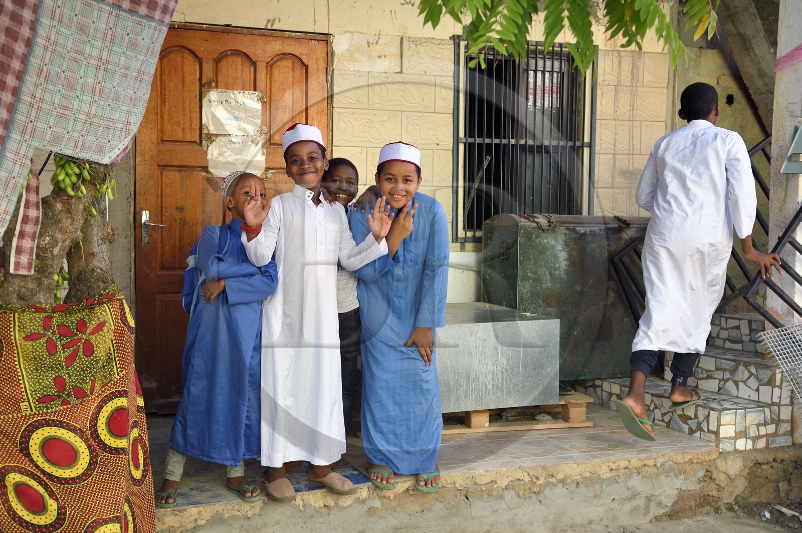 France, Mayotte island (French overseas department), Grande-Terre, Sada, children wearing an embroidered kofia, traditional Comoran hat, coming out of the madrassa