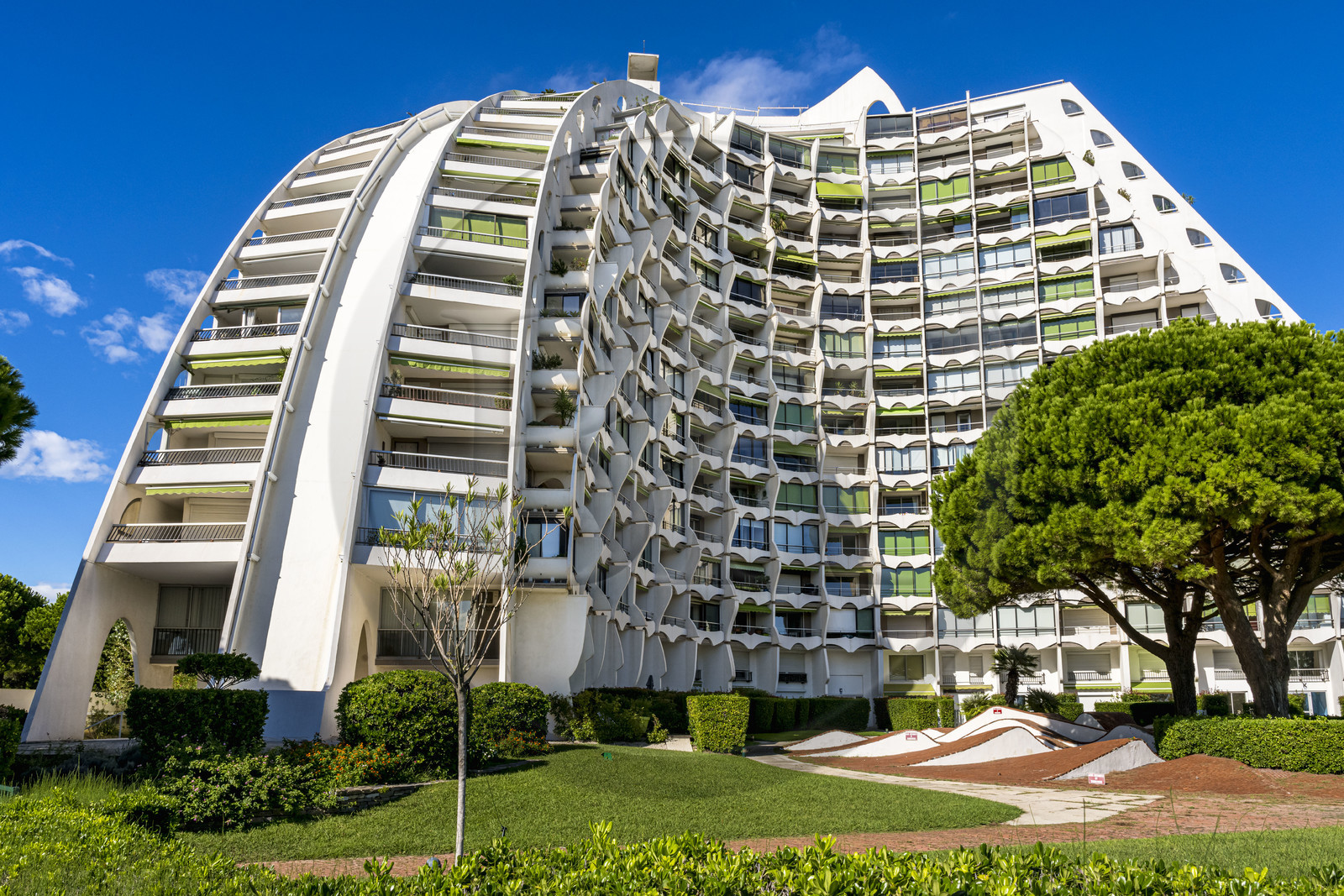 France, Herault, La Grande-Motte, labeled 20th century heritage, The Great Pyramid built in 1974 by the architects Jean Balladur and Jean-Bernard Tostivint, this flagship building for the port of the seaside resort dominates the whole city, forms a curved Y plan and houses a hotel and apartments