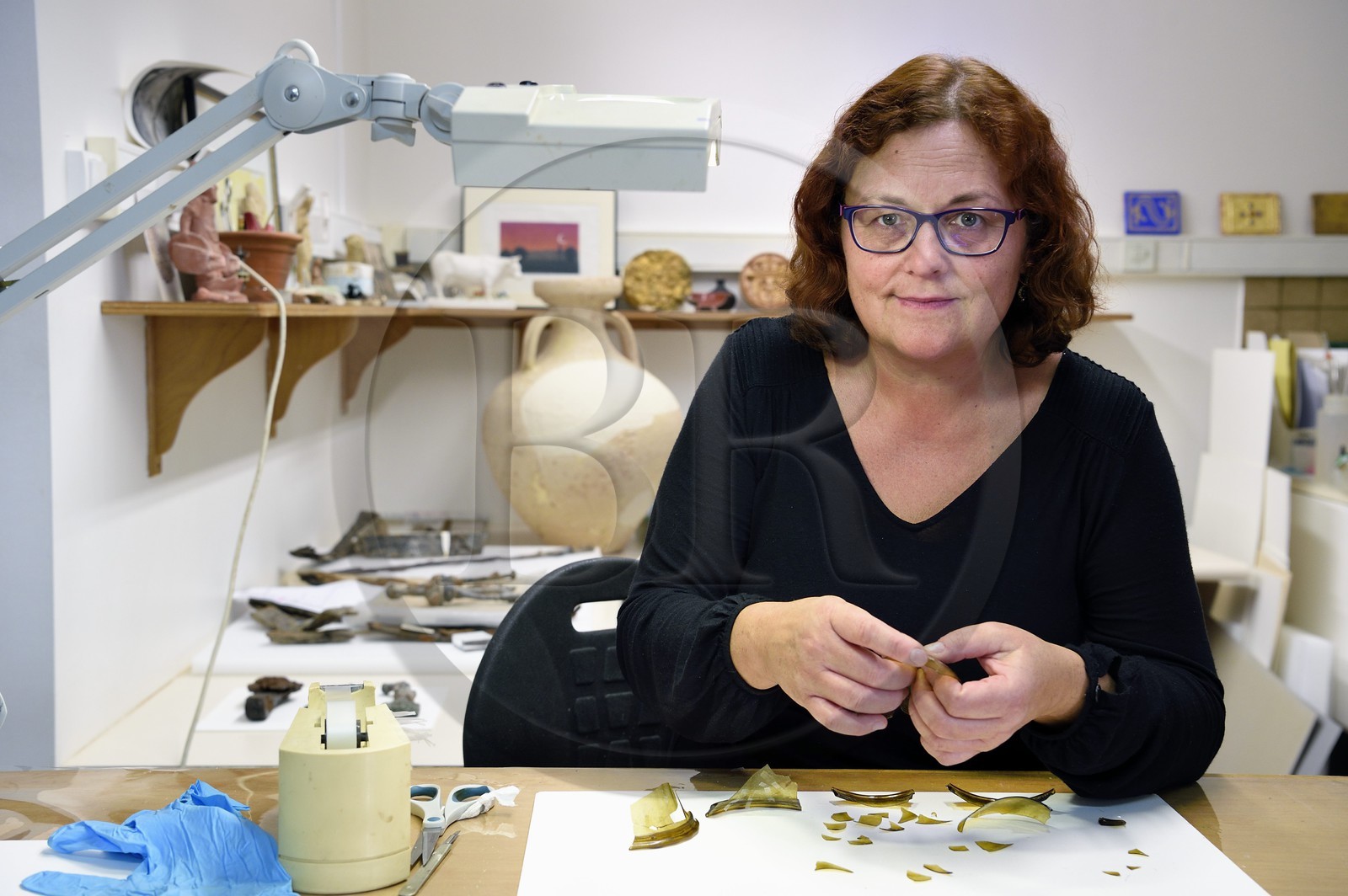 France, Calvados, Caen, the ducal castle of William the Conqueror, restoration laboratory, the restorer Lucie Voracek reconstitutes a Merovingian glass