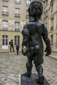 France, Paris, Musée Maillol art museum, sculpture Der Morgen oder Hölderlin, 2011, Painted bronze by the artist Markus Lüpertz, sculpture by Aristide Maillol, Chained Action, 1905, bronze in the background