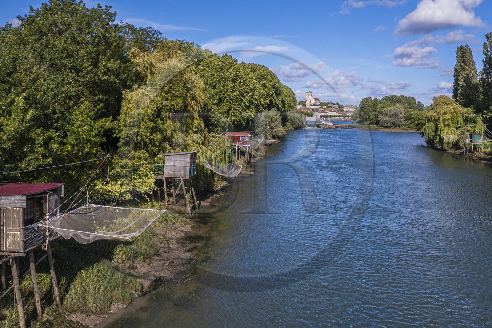 France, Charente-Maritime, Saintonge, Saint-Savinien, labeled stones and water villages, fishing huts with a net along the Charente river  and the village in the background (aerial view)