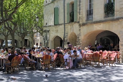 France, Gard, Uzes, listed as town of art and history, the Place aux Herbes surrounded by arcaded houses and its outdoor cafes