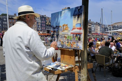 France, Calvados, Honfleur, the local painter Daniel Lallemand painting the Vieux-Bassin (Old Basin)