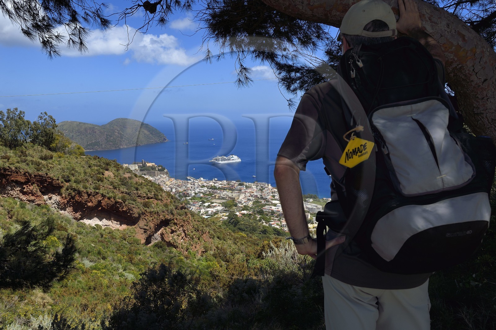 Italy, Sicily, Aeolian Islands, listed as World Heritage by UNESCO, Lipari Island, Lipari, hiker observing Lipari dominated by his citadel