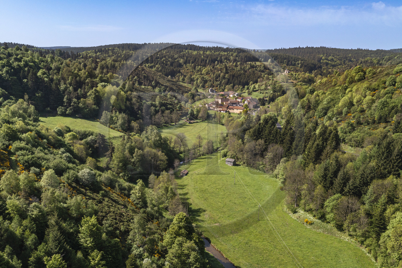 France, Lozere, Cheylard-l'Evêque, hiking with a donkey on the Stevenson trail (GR 70), the village in the valley (aerial view)