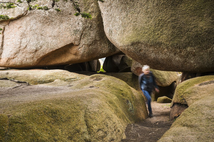 France, Cotes-d'Armor, Cote de Granit Rose, Trégastel, Renote island, hiker in the granite chaos