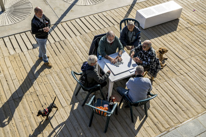 Spain, Catalonia, Barcelona, La Barceloneta, domino players on the beach