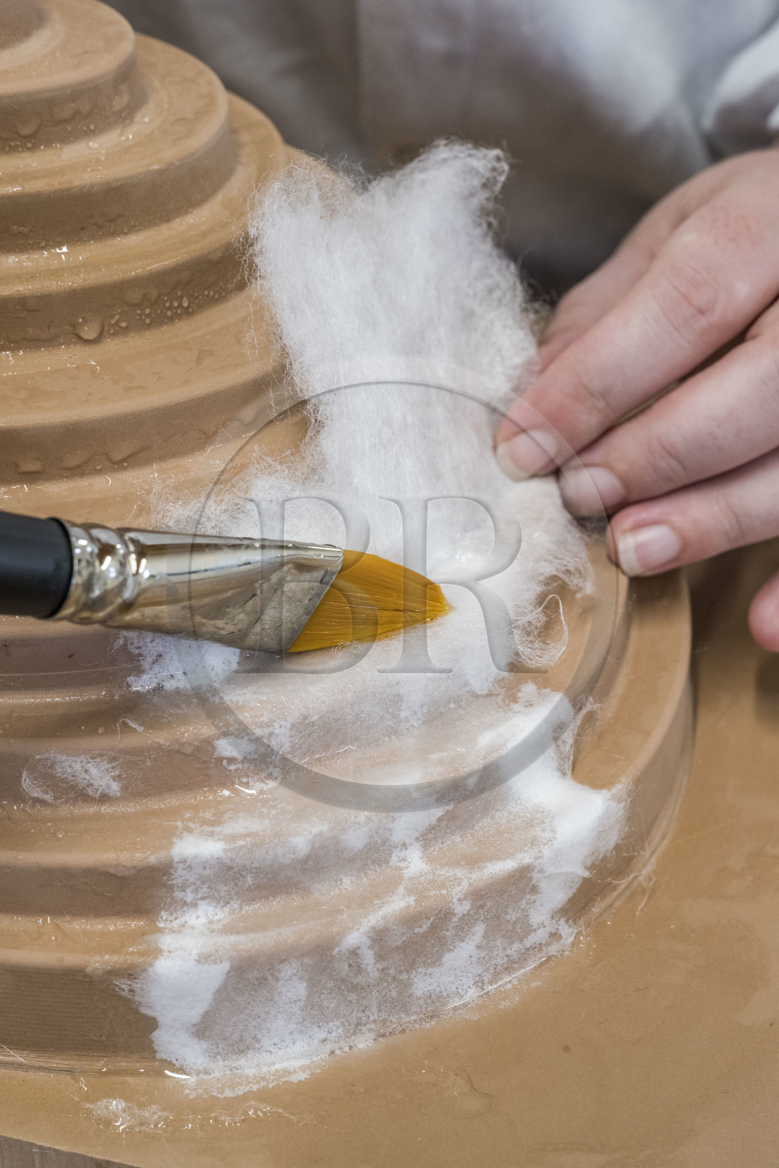 France, Gard, Bagard, Atelier Sericyne, production of exceptional and non-woven silk for the creation of decorative and lifestyle objects in silk, placement of a piece of silk threads on a mold with brush and water application