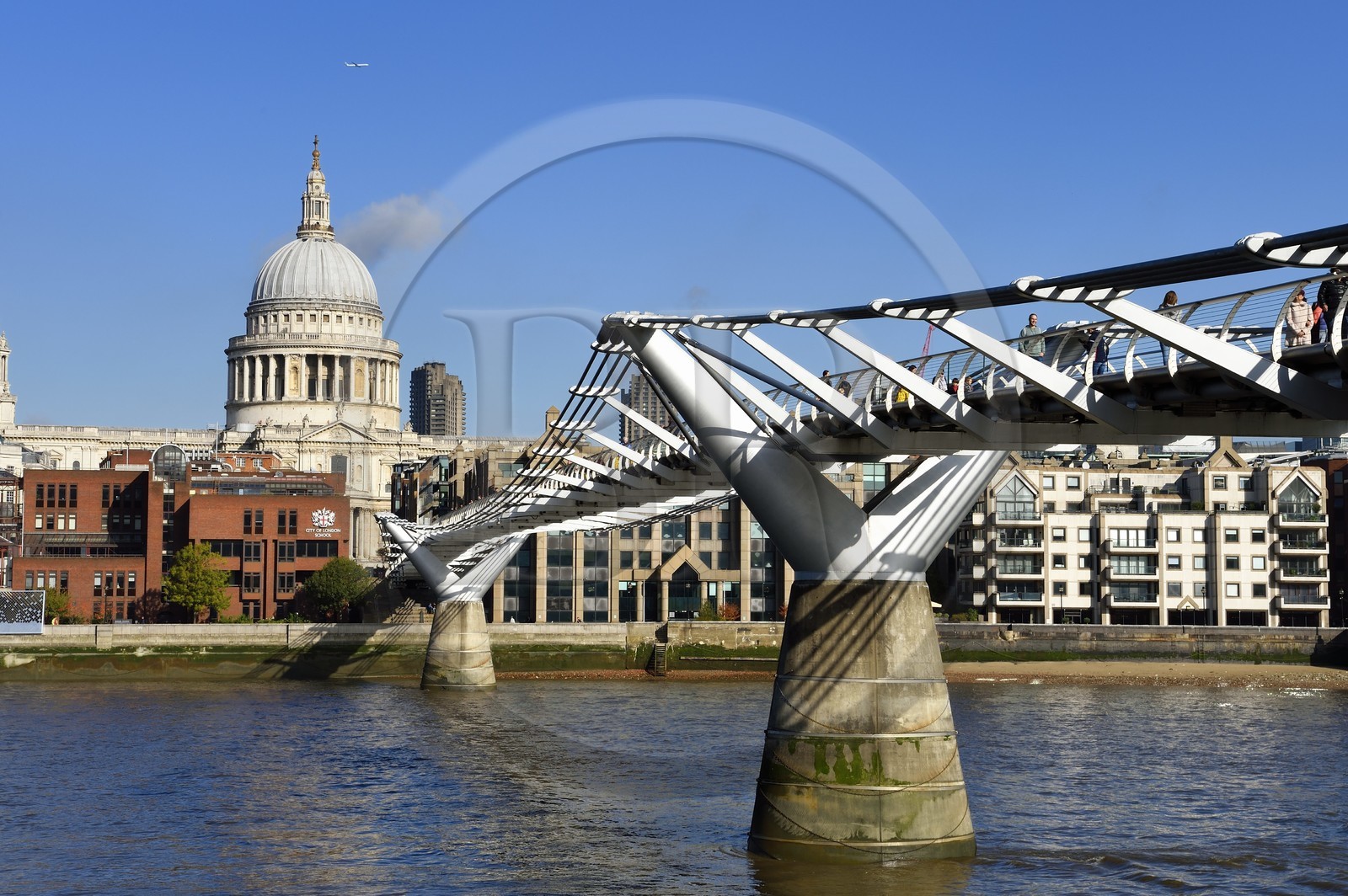 United Kingdom, London, the City, the Millennium Bridge by architect Norman Foster on the Thames river and St. Paul's Cathedral in the background