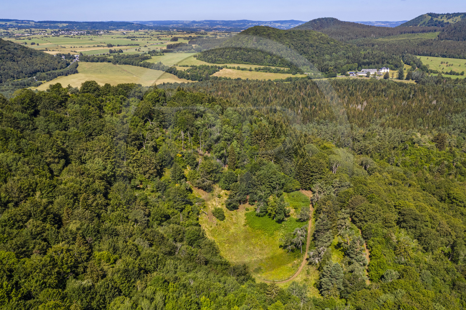 France, Puy de Dome, Aydat,  Parc Naturel Régional des Volcans d'Auvergne (regional nature park of Auvergne volcanoes), the Puy de Vichatel volcano, the Maison du Parc at the Chateau de Montlosier in the background on the right (aerial view)