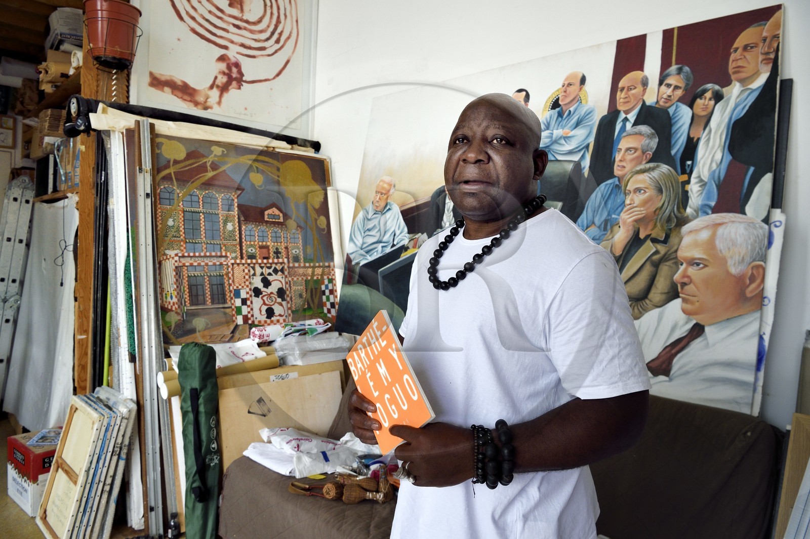 France, Paris, Barthelemy Toguo, the artist founder of Bandjoun Station in Cameroon (shown in the painting in the background), in his Parisian studio
