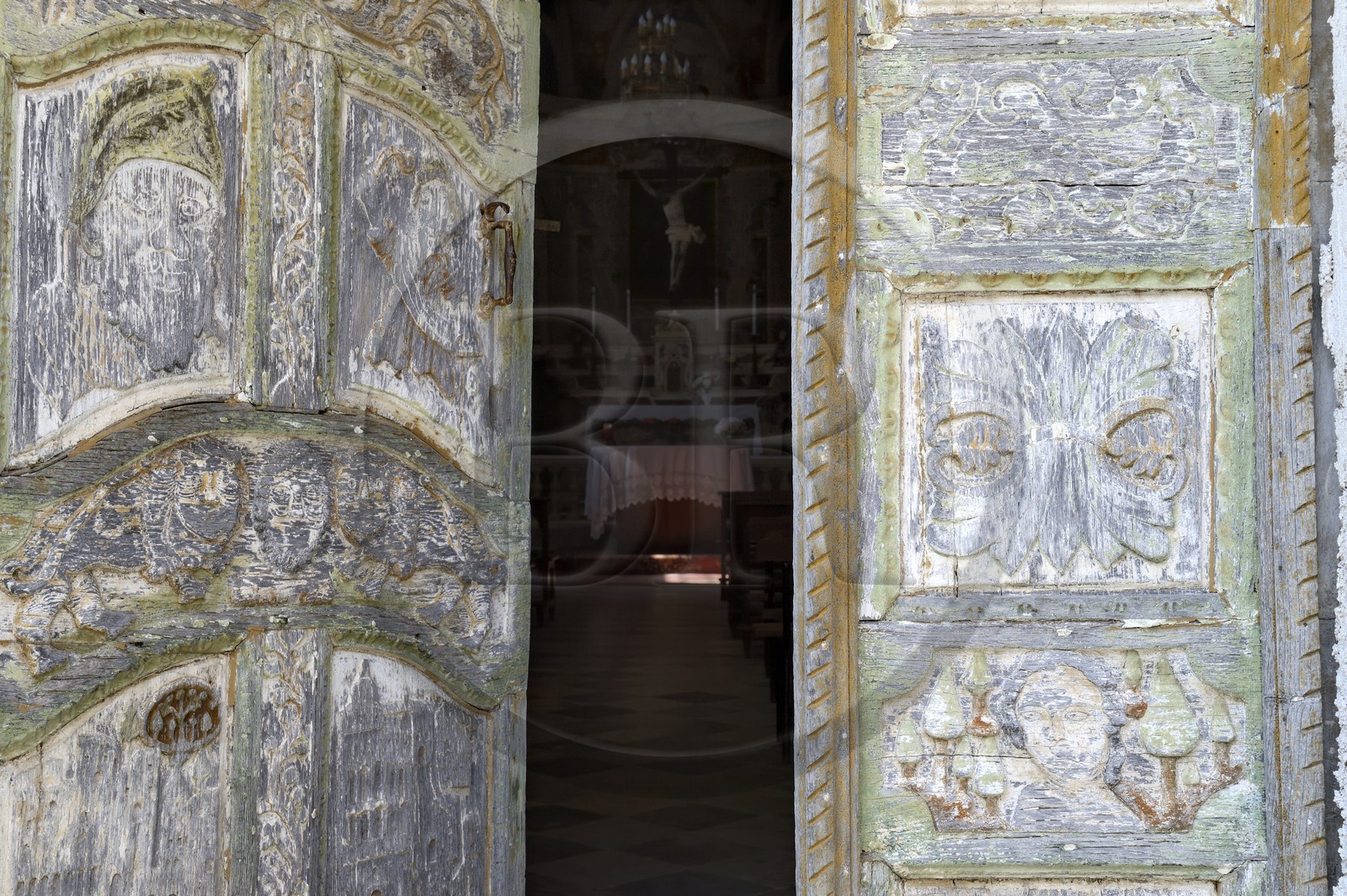 France, Haute Corse, Castagniccia, village of Piazzole d'Orezza, Church of the Annunciation, the tradition reported that a repentant bandit carved on the door of the church several biblical scenes (the announcement to Mary, David and Goliath) and a beautiful scenery of vineyards and wheat