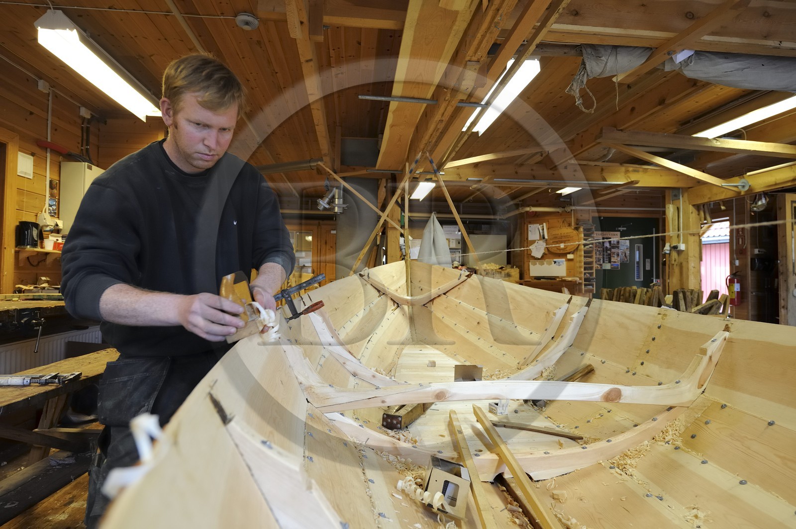 Norway, Hordaland County, Norheimsund, Fartoyvernsenter Boat Preservation Centre, renovation workshop, wooden boat with oar traditionally built by Bjorn Kvalvik