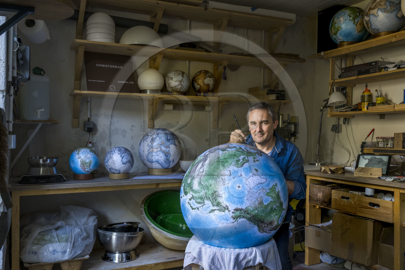 France, Charente, Cognac, Gabriel Gaborel, creator of OrbisTerrae, manufactures handcrafted terrestrial globes painted in watercolor