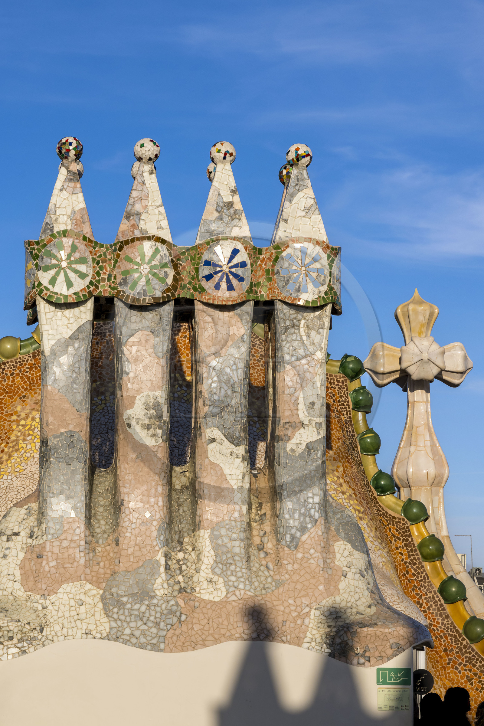 Spain, Catalonia, Barcelona, Eixample district, Passeig de Gracia, Casa Batllo by Catalan modernist architect Antoni Gaudi, UNESCO World Heritage site, chimneys, roof suggesting a dragon's spine and tower crowned with a ceramic spire surmounted by a typical Gaudi cross