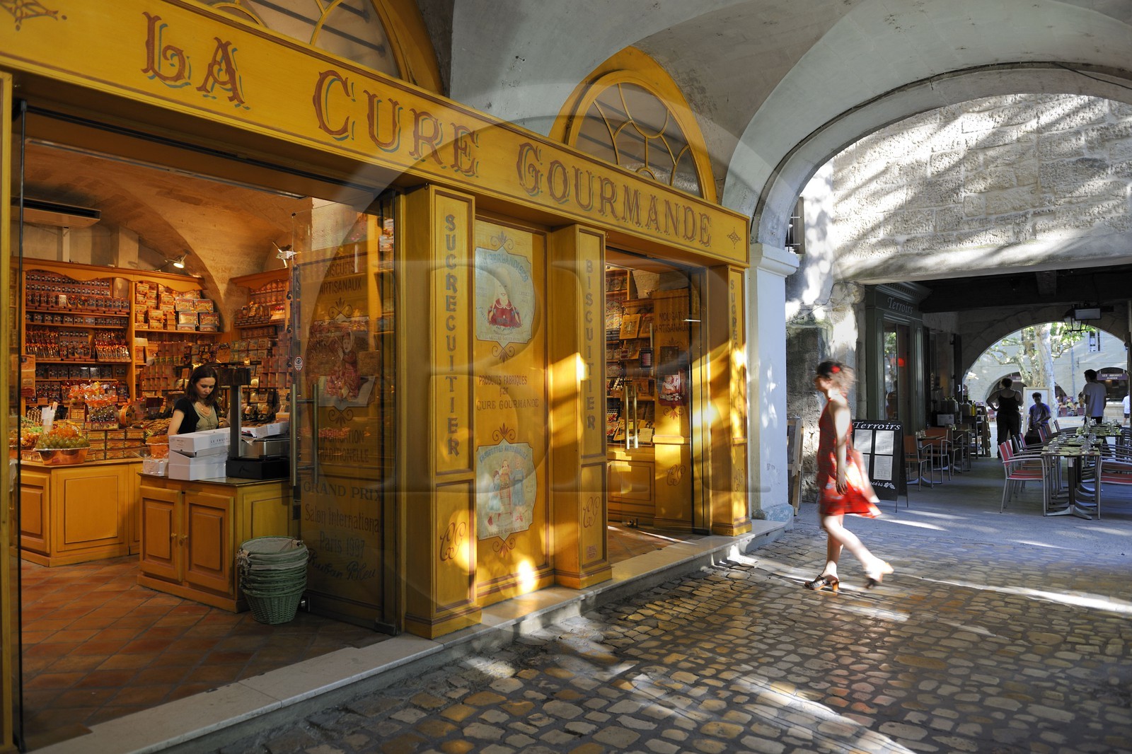 France, Gard, Uzes, listed as town of art and history, the weekly market in the Place aux Herbes surrounded by arcaded houses and outdoor cafes